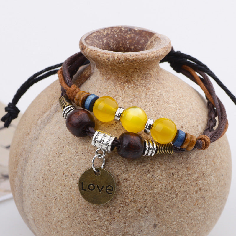 Handgewebtes Damenarmband aus Wachsseil mit Kristallperlen.